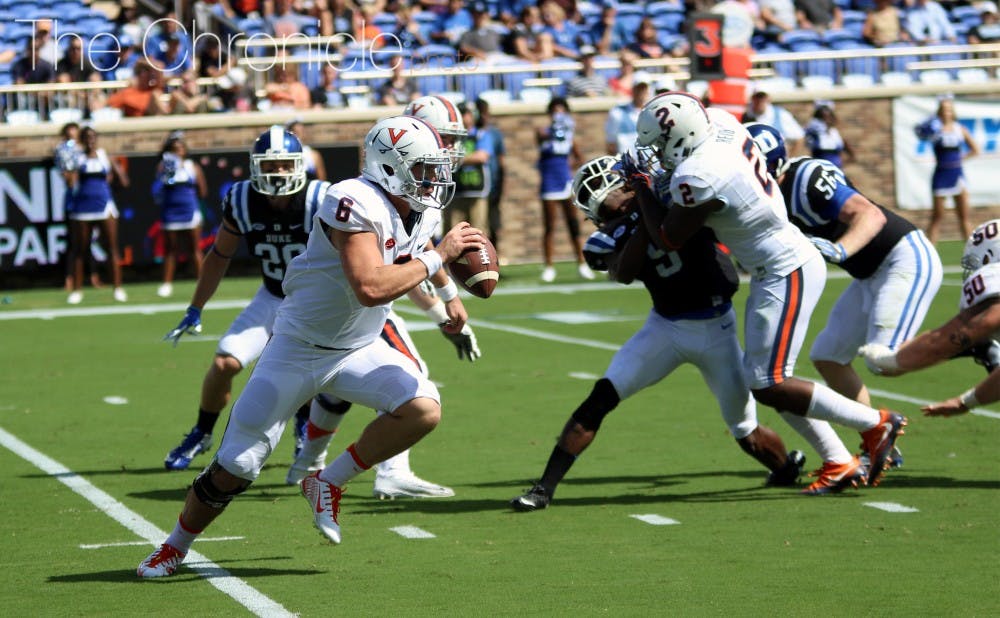 Virginia quarterback Kurt Benkert threw for more than 250 yards and two touchdowns in the first half, creating several big plays after escaping the pocket.