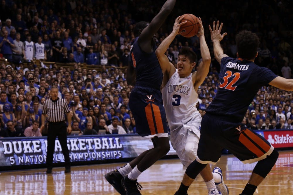 Grayson Allen powered through strong defense by Marial Shayok to get off his game-winner before time expired.