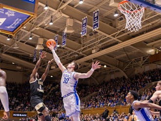 Kyle Filipowski swats the ball away during the first half of Duke's Monday night clash with Wake Forest.