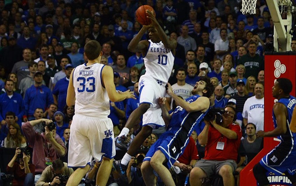 Ryan Kelly attempts to draw a change against Kentucky’s Archie Goodwin.