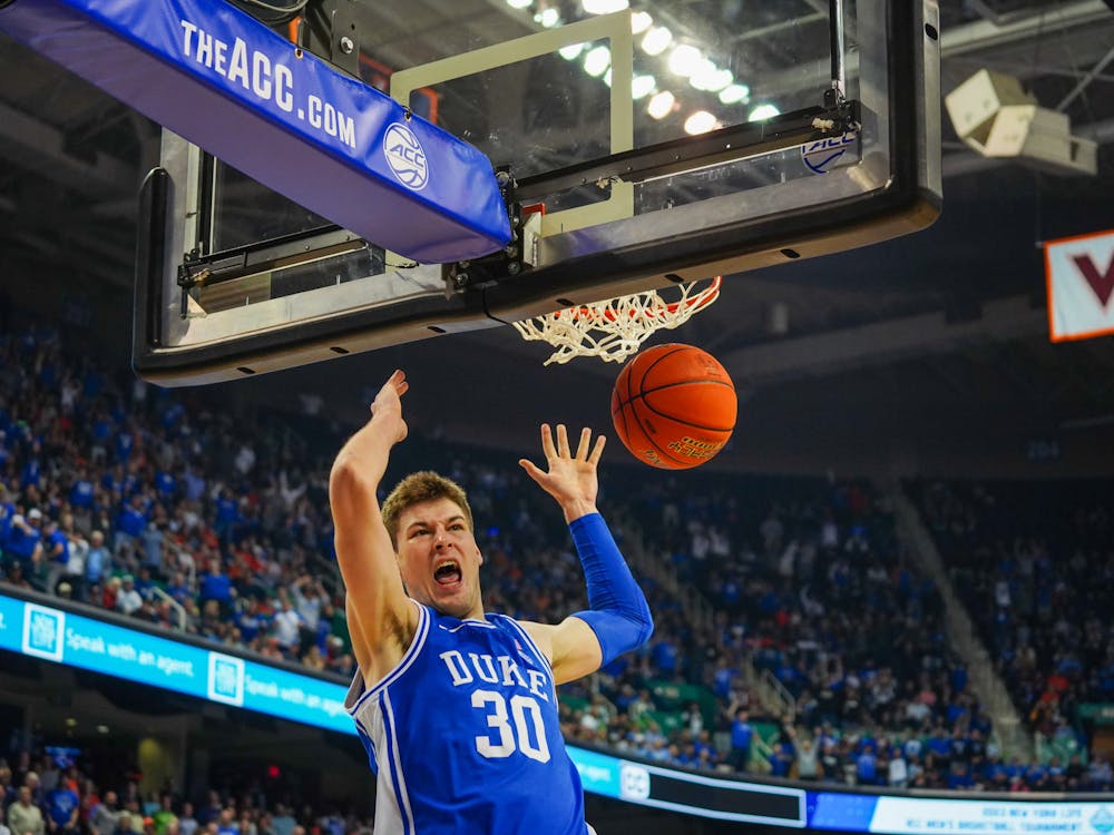 Kyle Filipowski finishes a fast-break dunk in the second half of the ACC tournament championship game.