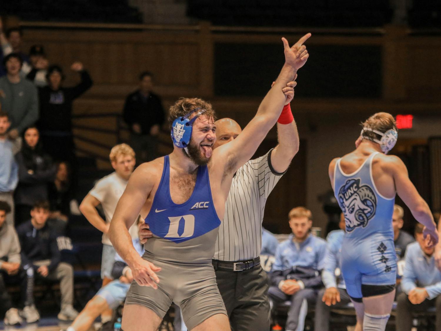 Vincent Baker celebrates a win at 197 pounds against North Carolina's Max Shaw.