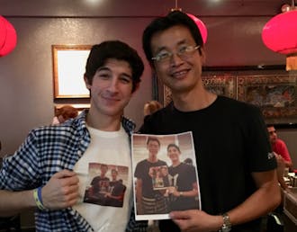 Besner (left) poses with waiter Peter Chung (right).