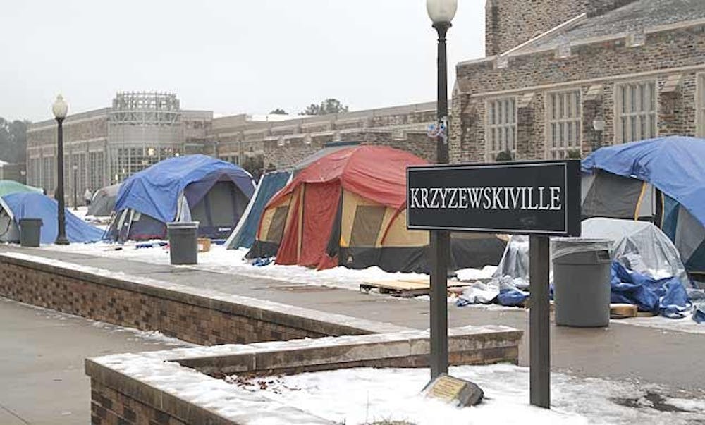 Students battle the elements in K-ville Tuesday during the end of  a storm that blanketed the tent city in snow and ice.