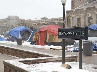 Students battle the elements in K-ville Tuesday during the end of  a storm that blanketed the tent city in snow and ice.