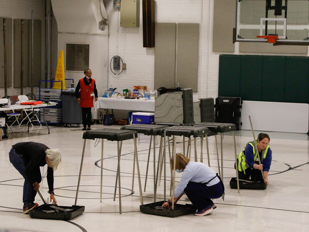 <p>Poll workers begin to close down the polling site at Precinct 2 at 7:30pm.</p>