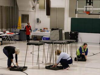 Poll workers begin to close down the polling site at Precinct 2 at 7:30pm.