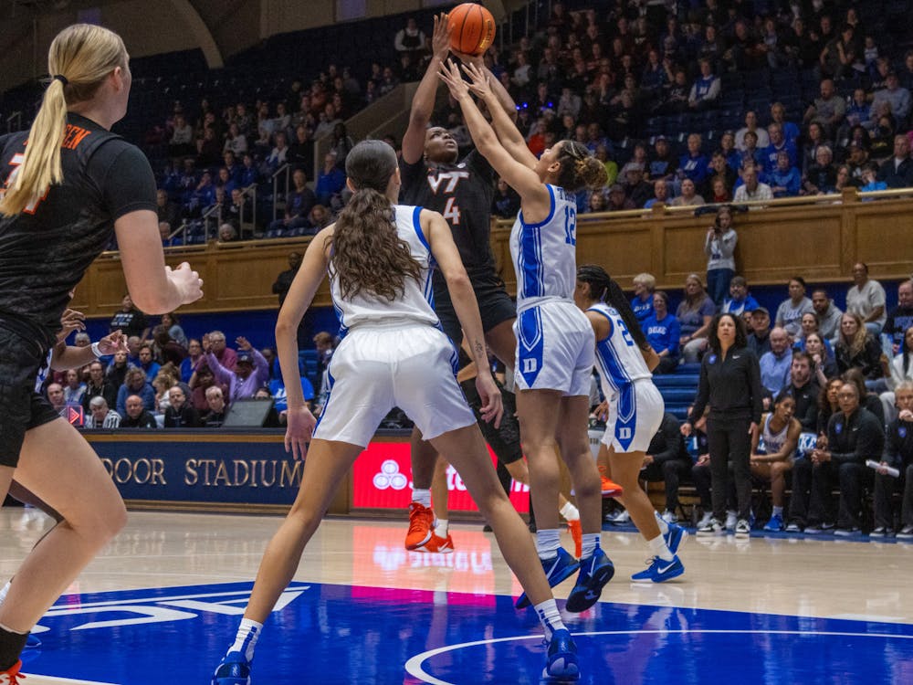 Delaney Thomas goes up for a block against Virginia Tech. 