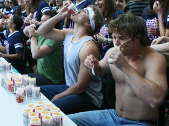 Students participate in a yogurt-eating contest on the Main West Quadrangle Friday. The event was part of ZTA’s breast cancer fundraiser.