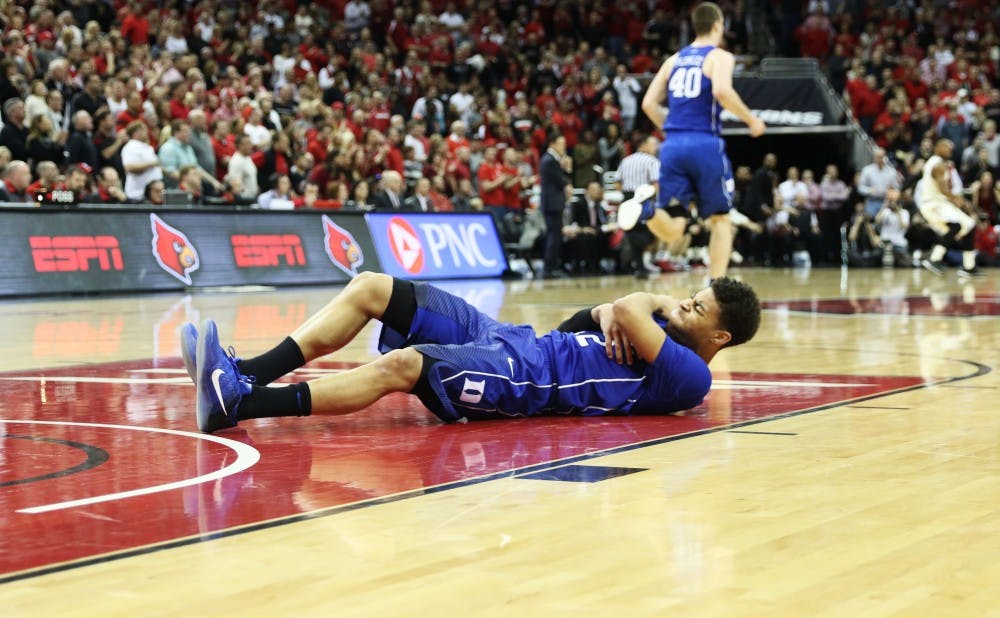Freshman Derryck Thornton grabs his shoulder in pain after falling awkwardly midway through the second half of Saturday's 71-64 loss at Louisville.