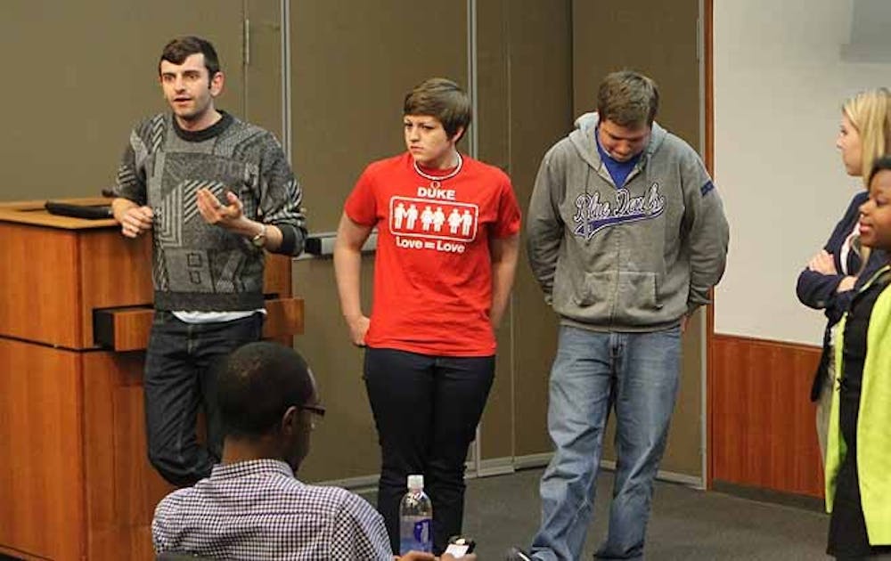 Junior Jacob Tobia, DSG senator for residential life (left), talks about expanding Duke’s health care plan to include sexual reassignment surgery at the group’s Wednesday meeting.