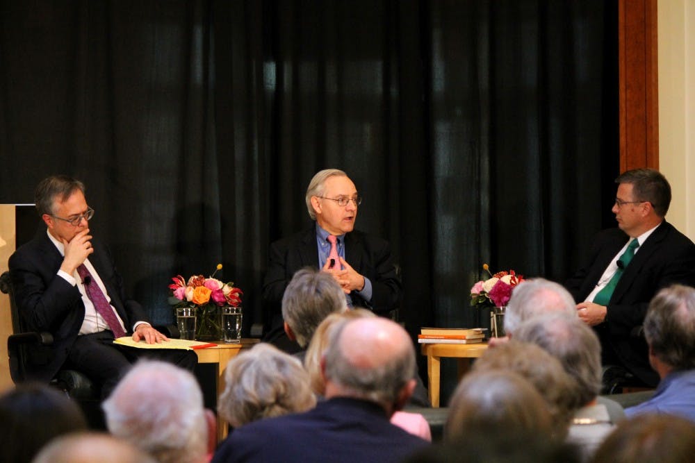 Columnists Michael Gerson (left) and E.J. Dionne (center) talk at the Sanford School of Public Policy Tuesday.