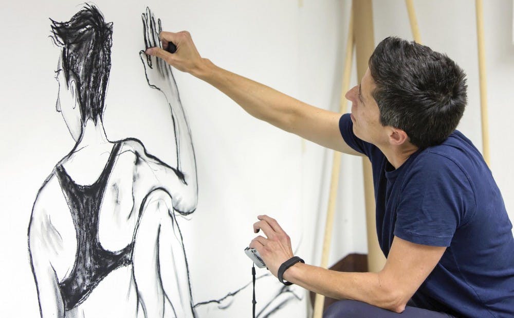 U.S. cartoonist Alison Bechdel portrayed as she works in her studio at the castle of Civitella Ranieri, central Italy, Tuesday, Sept. 2, 2014. 