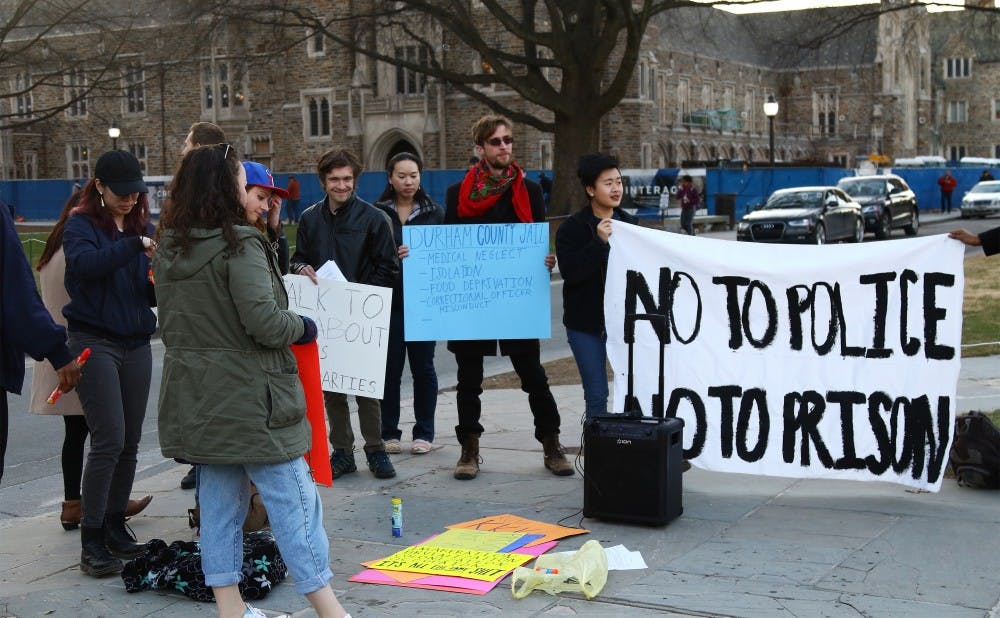 <p>Protestors gathered at the West Campus bus stop before marching toward the Delta Sigma Phi bench on the main West Campus quadrangle.</p>