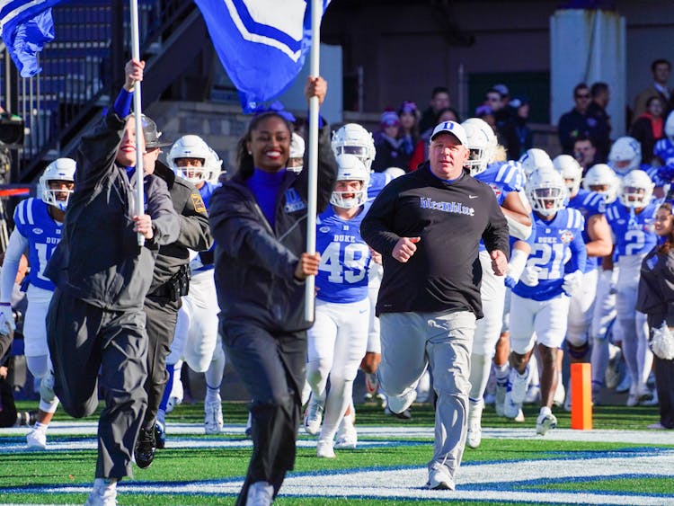 Mike Elko and the Blue Devils run onto the field for one last time in 2022.