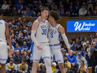 Tyrese Proctor (right) embraces Kyle Filipowski during Duke's loss to Pittsburgh.