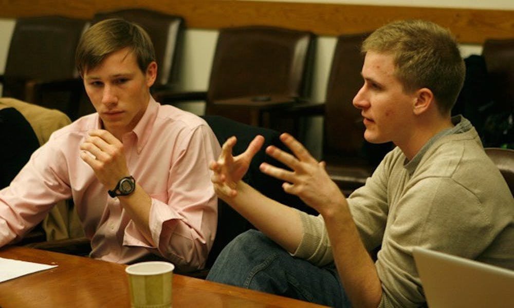 Campus Council President Stephen Temple (left) and Vice President Alex Reese (right) discuss revisions to the RGAC process at the group’s meeting Thursday night. Damage caused by individuals may negatively impact a group’s RGAC score in the future.