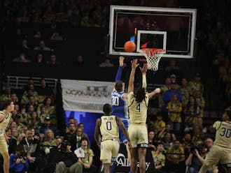 Kyle Filipowski battles for a rebound during the first half of Duke's clash with Wake Forest.