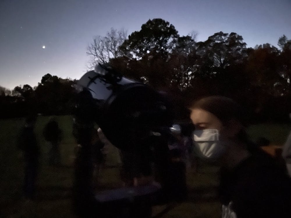 Alison peering into the telescope.