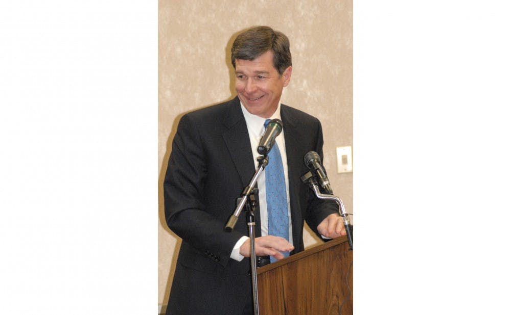 Roy Cooper, North Carolina Attorney General, gives a keynote address to Airmen during the opening ceremony of Military Saves Week at the Airman and Family Readiness Center Feb. 23.
