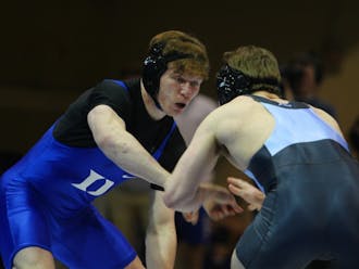 Conner Hartmann has benefited from the guidance of assistant coach Ben Wissel both on and off the mat.