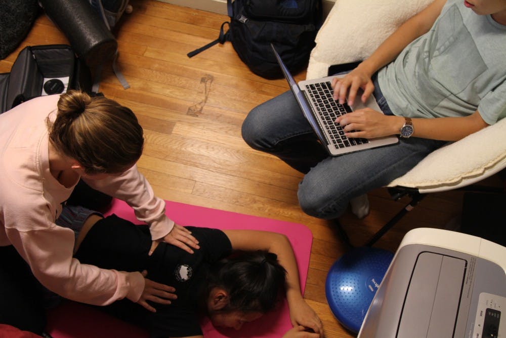 <p>First-years Lyndsay Hastings and Yuexuan Chen took turns giving back massages to help de-stress.</p>