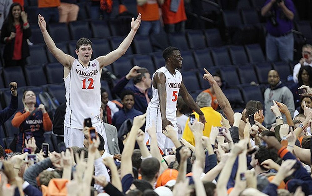 Joe Harris, left, celebrates with fans after scoring a career-high 36 points to lead Virginia to an upset win over No. 3 Duke.