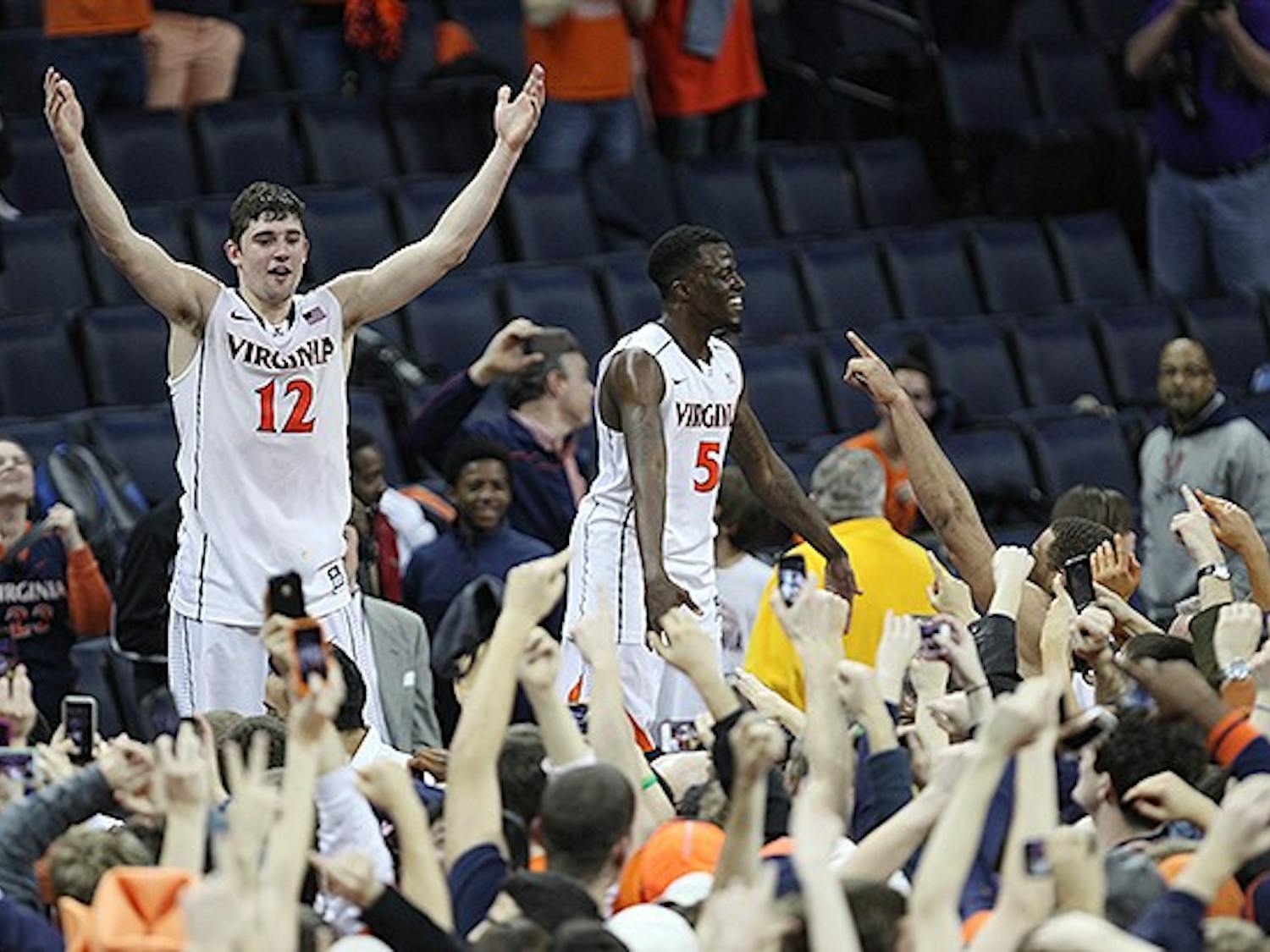 Joe Harris, left, celebrates with fans after scoring a career-high 36 points to lead Virginia to an upset win over No. 3 Duke.