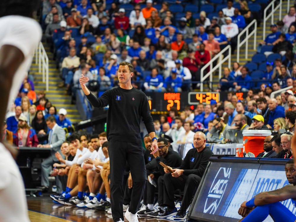 Jon Scheyer coaches from the sidelines during the ACC tournament.