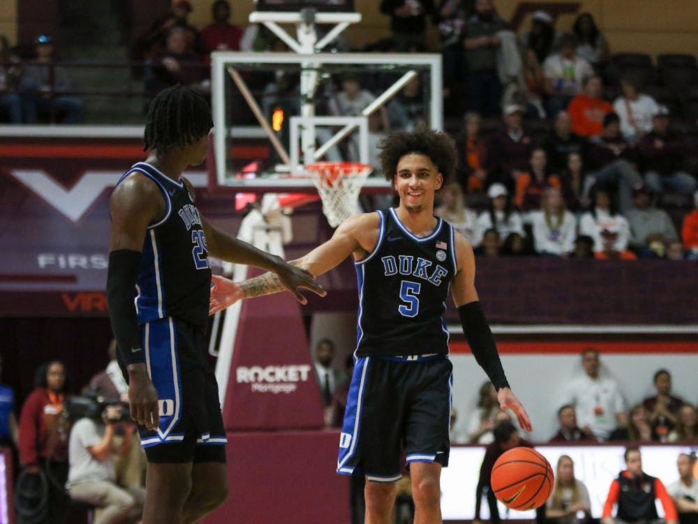 Tyrese Proctor (right) and Mark Mitchell (left) celebrate during Duke's road win against Virginia Tech.