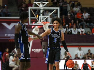Tyrese Proctor (right) and Mark Mitchell (left) celebrate during Duke's road win against Virginia Tech.