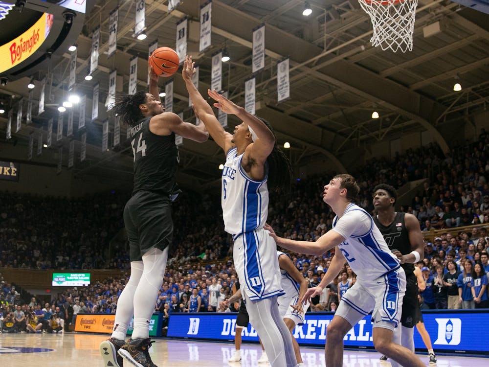 Maliq Brown defends a shot from Virginia Tech's Mylyjael Poteat. 