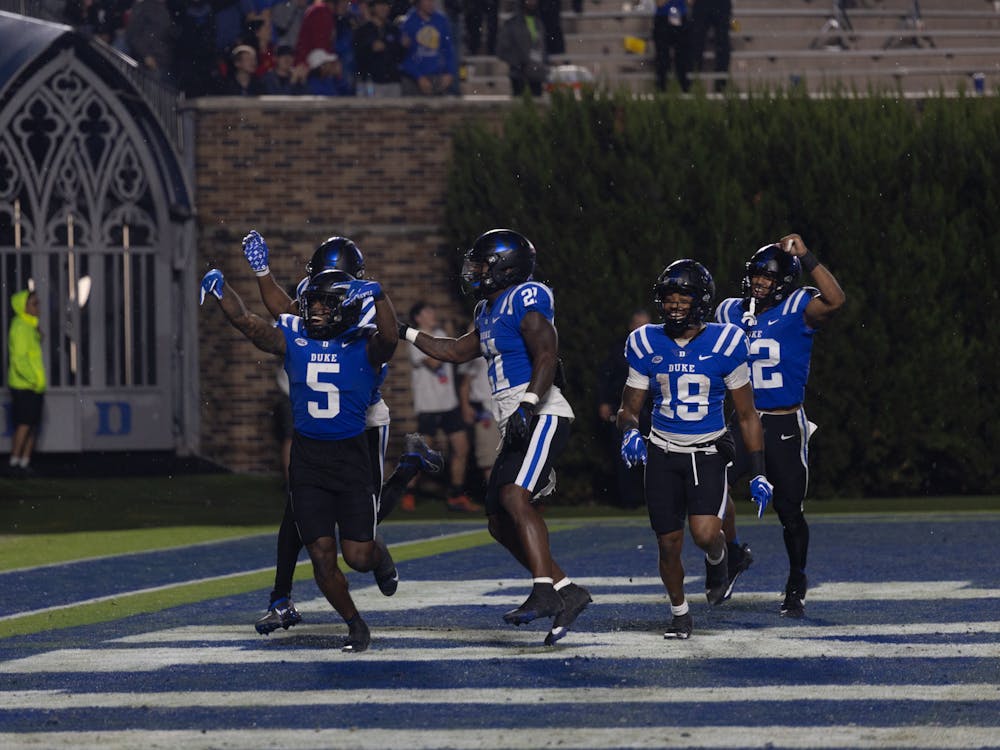 The Duke offense celebrates after scoring a touchdown against N.C. State Saturday.