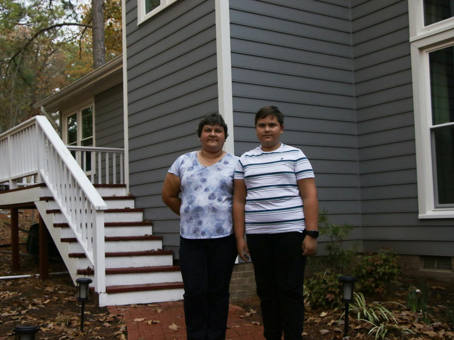 Liuda Skorlupina and her son Zhenia outside of Liuda's friend's home in Durham, where they are now staying after fleeing the war in Ukraine.&nbsp;