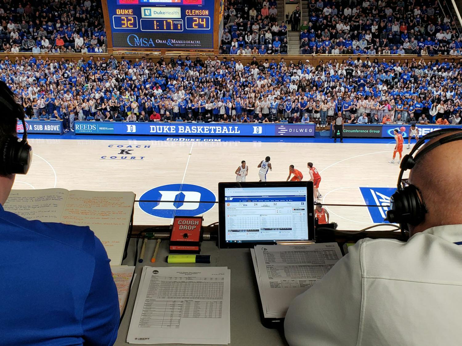 David Shumate (left) checks his notes in the broadcast booth during Duke's home game against Clemson.