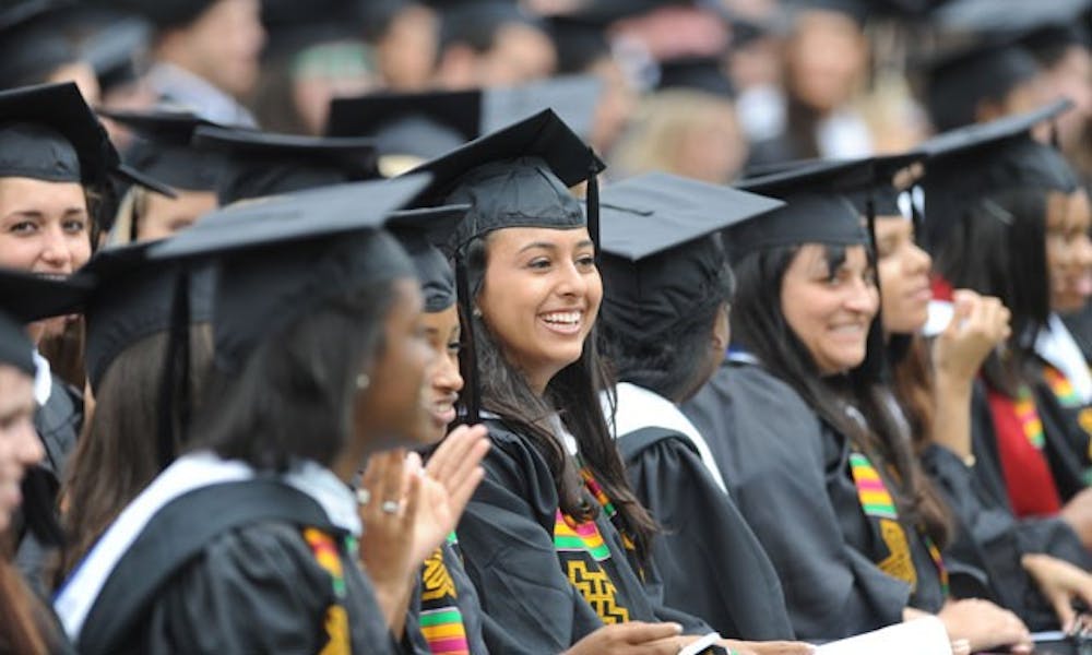 Students celebrate during the commencement ceremony Sunday in Wallace Wade Stadium. Cisco Systems CEO John Chambers delivered the commencement address.