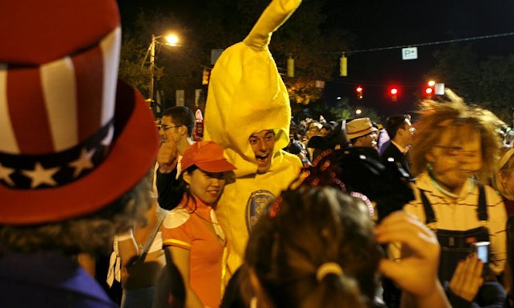 A partygoer dressed as a giant banana smiles for the camera to peals of laughter on Franklin Street during Halloween 2008. Last year’s celebration was the first that only Chapel Hill residents were allowed to attend.