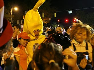 A partygoer dressed as a giant banana smiles for the camera to peals of laughter on Franklin Street during Halloween 2008. Last year’s celebration was the first that only Chapel Hill residents were allowed to attend.