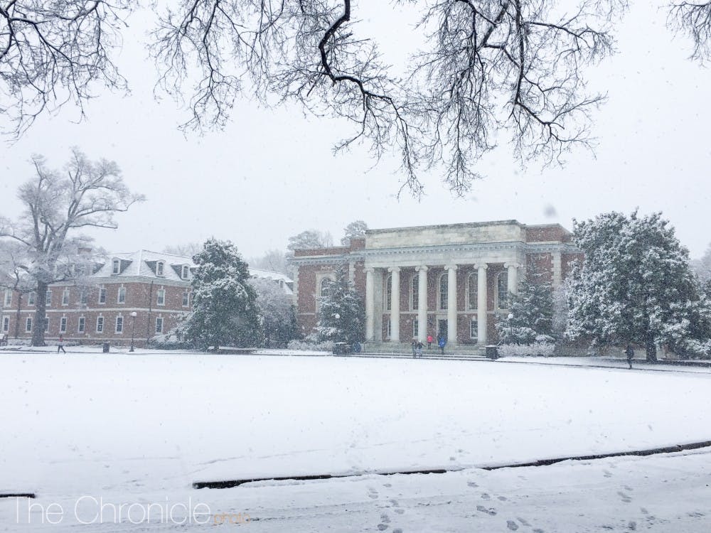 Snow covers the East Campus quad in front of Marketplace.
