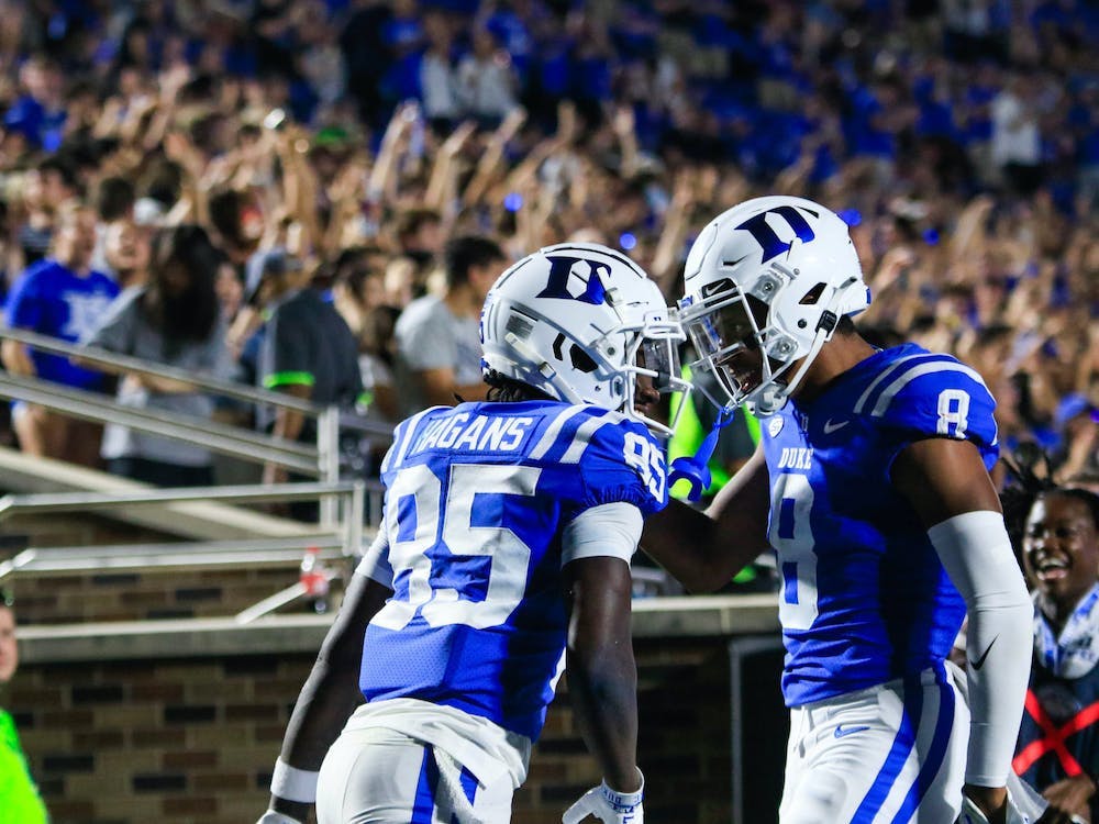 Sahmir Hagans (85) and Jordan Moore (8) celebrate a score in Duke's season-opening win against Temple in front of a new-look student section.
