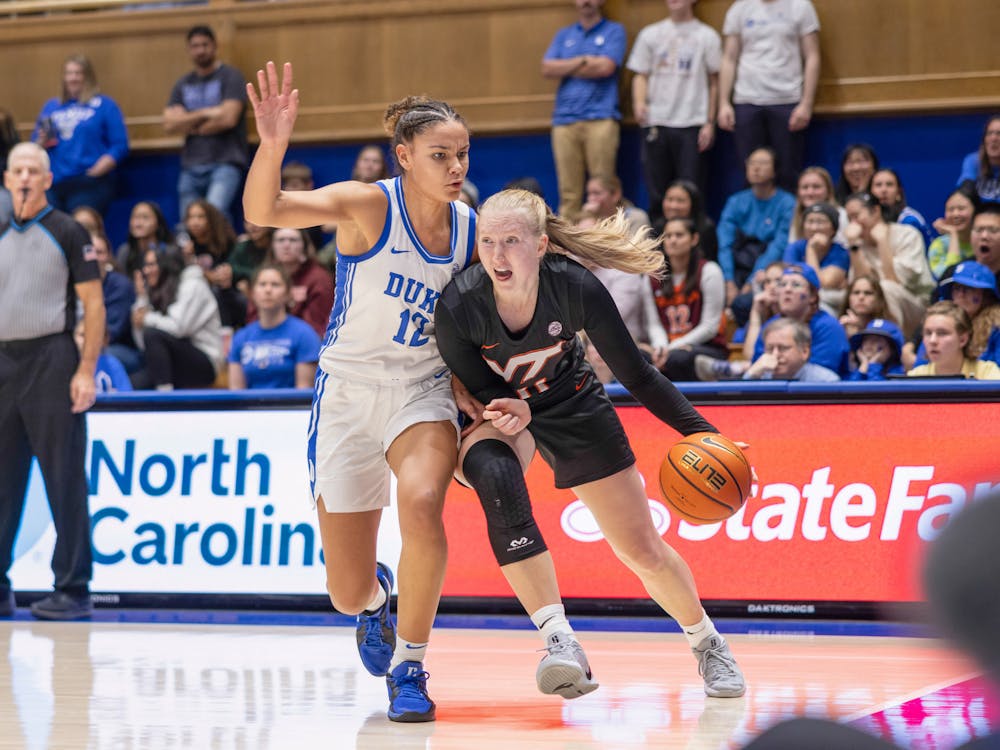 Delaney Thomas defends an opposing Virginia Tech attack. 