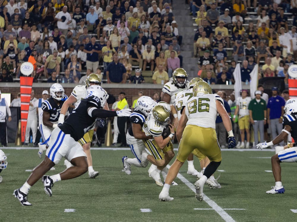 Graduate linebacker Alex Howard tackles Georgia Tech quarterback Haynes King.