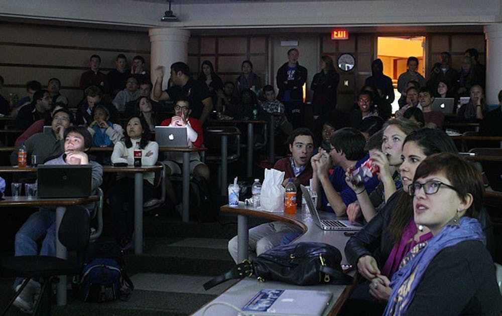 Students watch the results roll in at a watch party at the Sanford School of Public Policy.