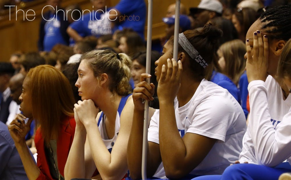 Injured redshirt freshman Lyneé Belton (middle) and sophomore Azurá Stevens could only watch from the sidelines as more Blue Devils suffered ailments in Sunday's loss to Georgia Tech.