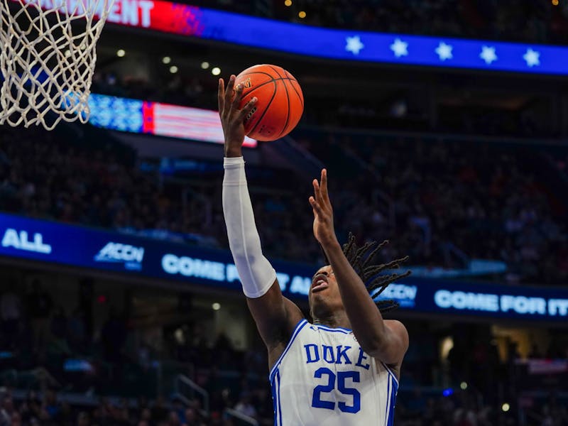 Mark Mitchell underhands the ball into the basket during Duke's ACC quarterfinal against N.C. State.