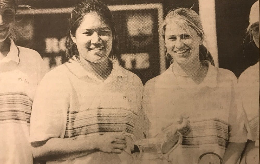 <p>Chuasiriporn&nbsp;(left) smiling after the Blue&nbsp;Devils captured their third consecutive ACC Championship in 1998.&nbsp;</p>
