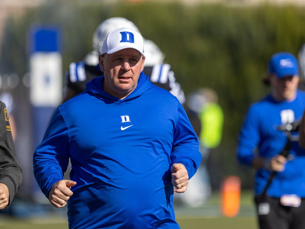 Mike Elko runs onto the field at Wallace Wade Stadium for the final time against Pittsburgh.
