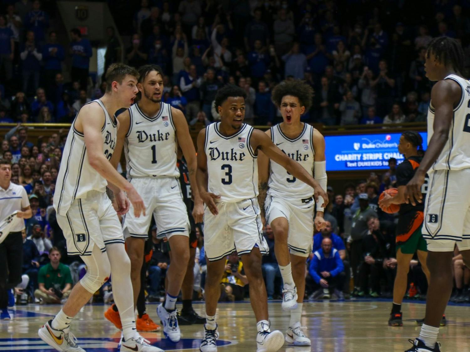 Duke players celebrate around captain Jeremy Roach (3) during a Jan. 21 win against Miami in Durham.