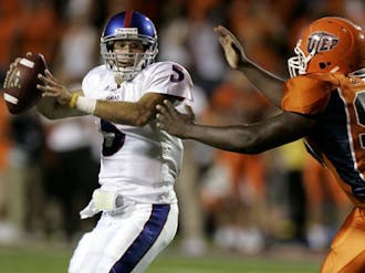 Weston White/KANSANSenior quarterback Todd Reesing scrambles out of the pocket to complete a pass to junior receiver Jonathan Wilson. Reesing connected on 25 of his 41 passes for 260 yards and one touchdown Saturday evening against UTEP. 