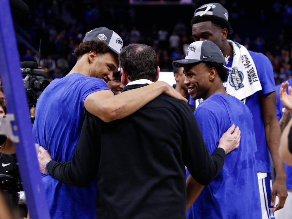 Mike Krzyzewski and the Blue Devils celebrate making the Final Four after defeating Arkansas in the Elite Eight.